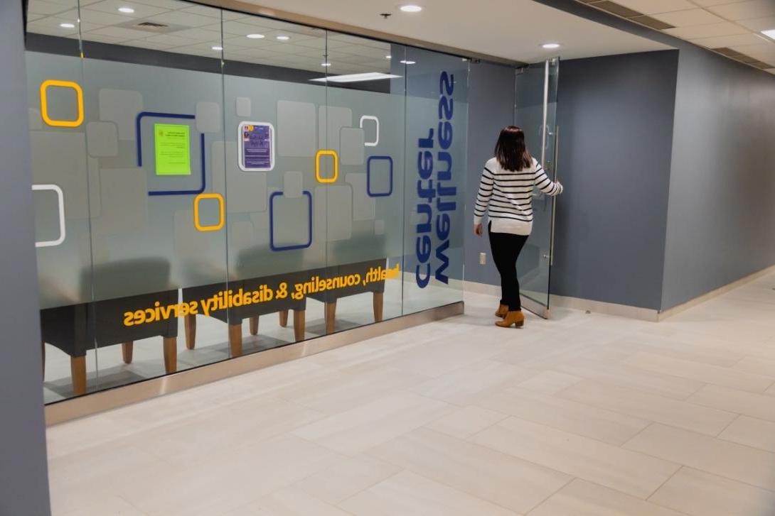 A student walks through the door of the Wellness Center on campus